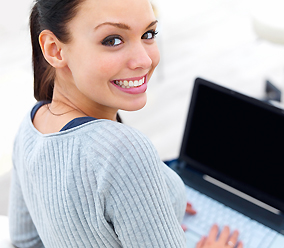 woman at desk computer happy helping