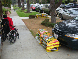 Brett in procured Wheelchair outside landscaping